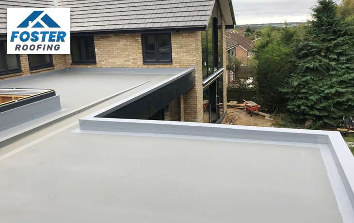 Flat commercial roof with white TPO material installed